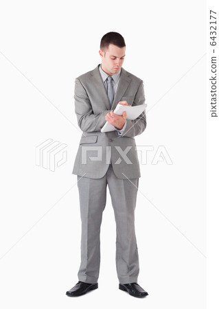 Portrait of a businessman taking notes 6432177