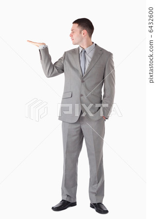 Portrait of a businessman presenting something 6432600