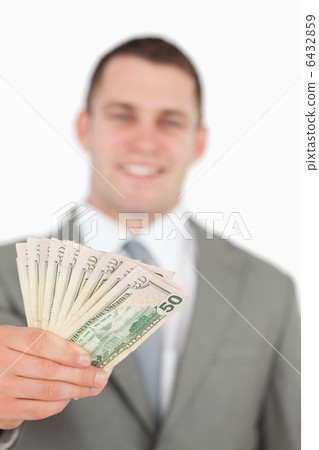 Portrait of a smiling businessman showing notes Portrait of a smiling businessman showing notes 6432859