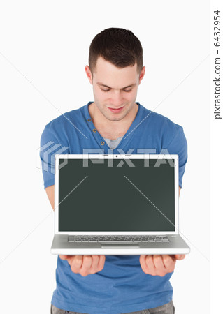 Portrait of a man looking at a laptop 6432954