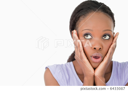 Close up of woman being afraid against a white background Close up of woman being afraid against a white background 6433087