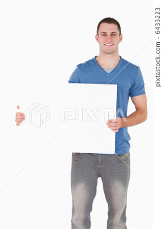 Portrait of a young man holding a blank panel 6433223