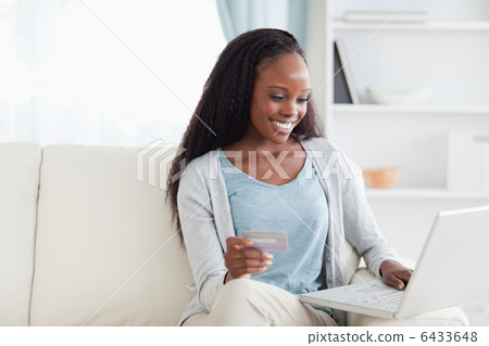 Woman in living room shopping online 6433648