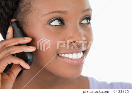 Close up of woman listening to caller on white background 6433825