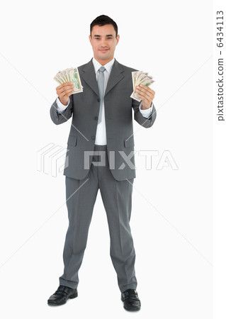 Successful businessman presenting banknotes Successful businessman presenting banknotes 6434113