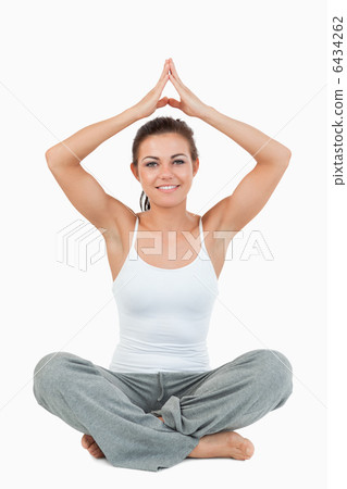 Portrait of a woman in a meditation position Portrait of a woman in a meditation position 6434262