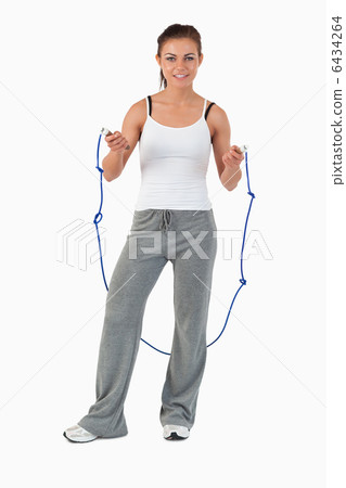 Young woman about to start jump roping Young woman about to start jump roping 6434264