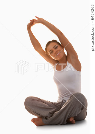 Portrait of a young woman stretching her back Portrait of a young woman stretching her back 6434265