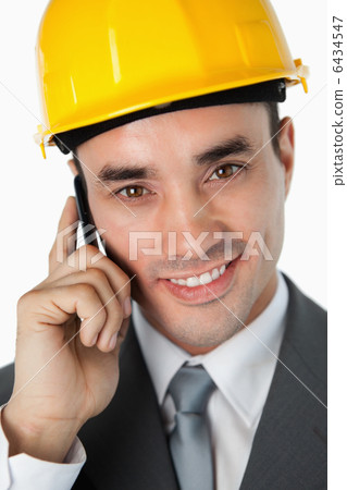 Close up of smiling architect talking on the phone 6434547