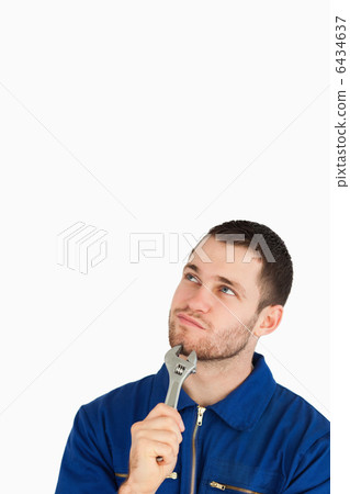 Young mechanic in boiler suit in thoughts Young mechanic in boiler suit in thoughts 6434637