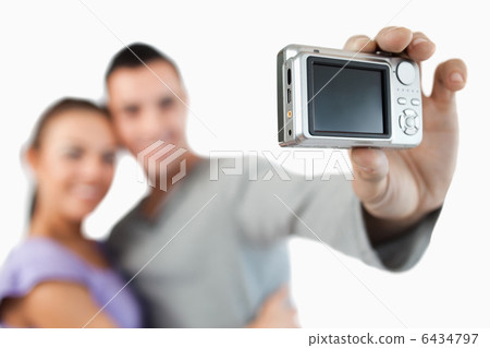 Camera being used to take a picture of young couple Camera being used to take a picture of young couple 6434797