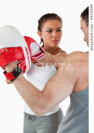 Young woman listening to her trainer Young woman listening to her trainer 6434999
