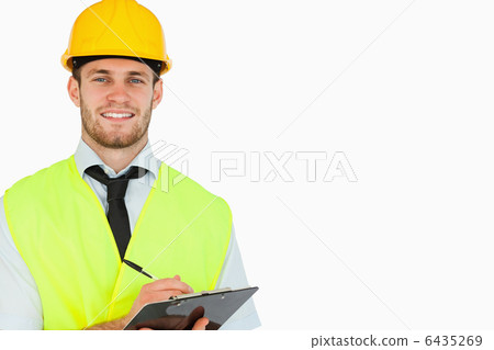 Smiling young lead worker with clipboard Smiling young lead worker with clipboard 6435269