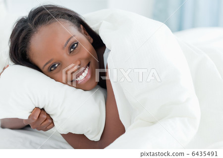 Close up of a young woman waking up Close up of a young woman waking up 6435491