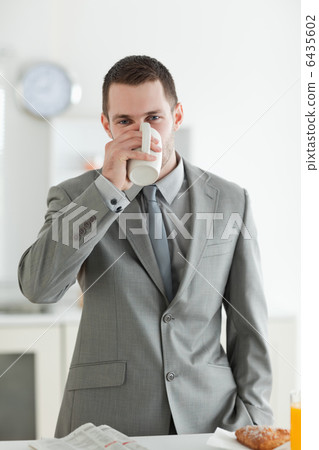 Portrait of a handsome businessman having breakfast Portrait of a handsome businessman having breakfast 6435602