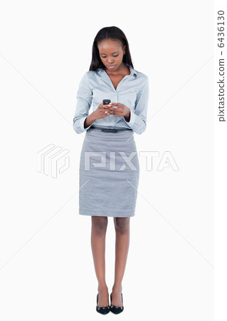 Portrait of a businesswoman sending a text message 6436130