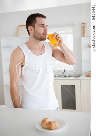 Portrait of a healthy man drinking orange juice 6436445
