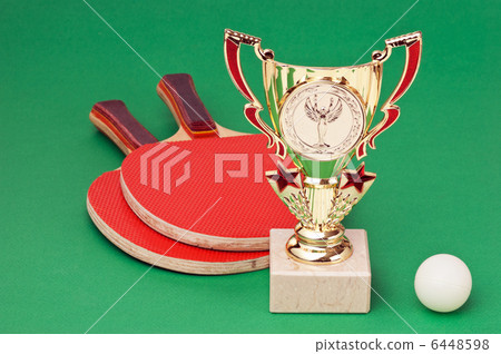 sports awards and tennis racquets on green table sports awards and tennis racquets on green table 6448598
