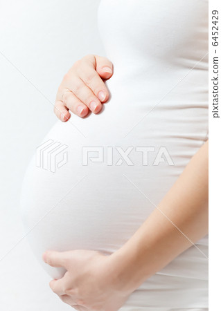 Pregnant woman touching here belly Pregnant woman touching here belly 6452429