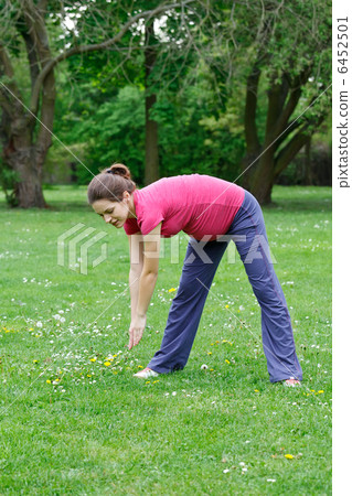 Pregnant woman exercising in the park Pregnant woman exercising in the park 6452501