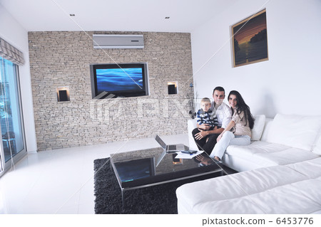 happy young family have fun with tv in backgrund happy young family have fun with tv in backgrund 6453776