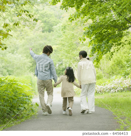 The back of the family holding hands in the fresh green 6456413