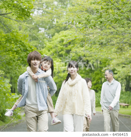 Three generation family walking in fresh green 6456415