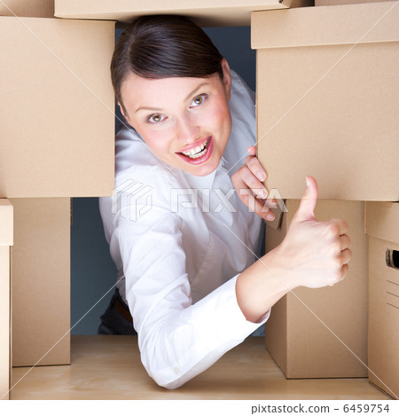 Portrait of young woman surrounded by lots of boxes. Lots of wor 6459754