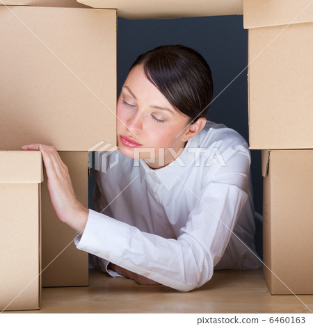 Portrait of young woman surrounded by lots of boxes. Lots of wor 6460163