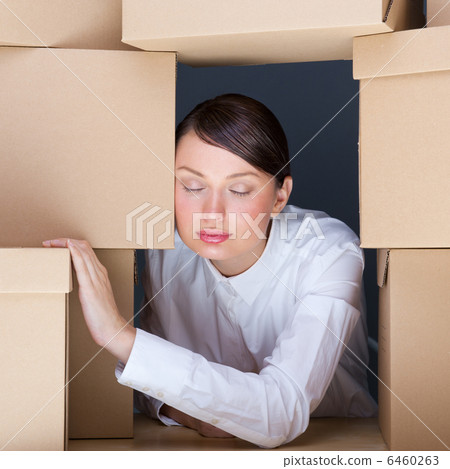 Portrait of young woman surrounded by lots of boxes. Lots of wor 6460263