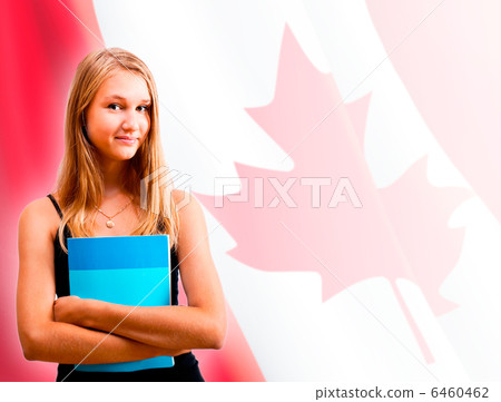 Portrait of pretty young woman holding book in her arms. Canadia 6460462