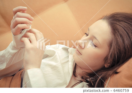 Closeup portrait of young pretty girl laying on her bed Closeup portrait of young pretty girl laying on her bed 6460759