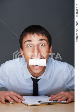 Closeup portrait of business man holding business card in his mo Closeup portrait of business man holding business card in his mo 6460993