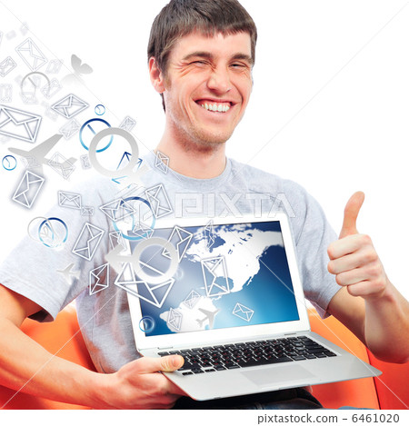 Closeup of a young smiling business man sitting at his home offi Closeup of a young smiling business man sitting at his home offi 6461020
