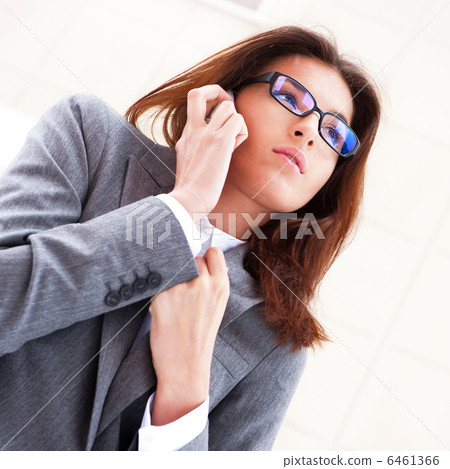 Beautiful business woman on the phone at modern building. Outdoo 6461366