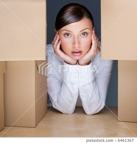 Portrait of young woman surrounded by lots of boxes. Lots of wor 6461367