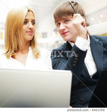 Two students working on their college project at hall using lapt 6461509