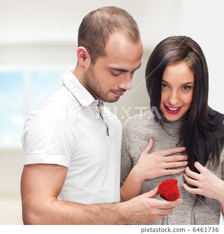 Young man making love proposal to a lady of his choice at their 6461736