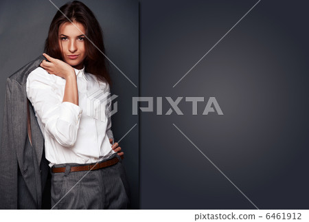 Portrait of a beautiful young business woman standing with hand 6461912