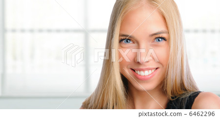 Young beautiful woman smiling at office. Standing against window 6462296