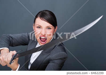 Business woman showing determination while holding a sword Business woman showing determination while holding a sword 6462299