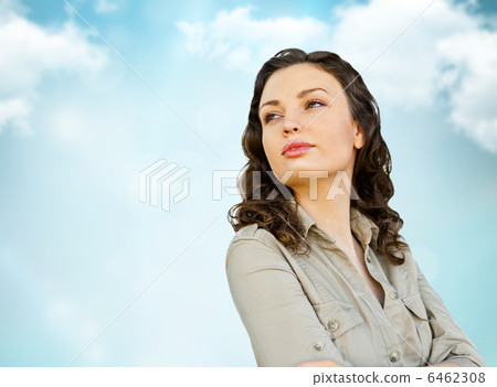 Young woman standing outdoors in front of beautiful sky Young woman standing outdoors in front of beautiful sky 6462308