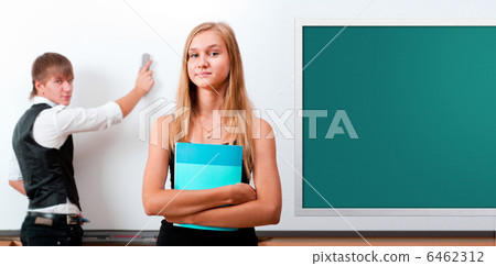 Two students - girl and boy making presentation at classroom Two students - girl and boy making presentation at classroom 6462312