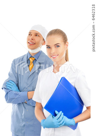 Closeup portrait of two young caucasian doctors standing togethe Closeup portrait of two young caucasian doctors standing togethe 6462318