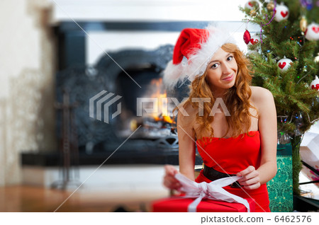 Christmas woman near a Christmas tree holding big gift box while 6462576