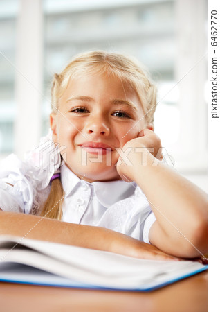 Portrait of a young girl in school at the desk. Portrait of a young girl in school at the desk. 6462770