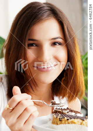 Young beautiful woman with a cake. Closeup portrait. Sitting on Young beautiful woman with a cake. Closeup portrait. Sitting on 6462784