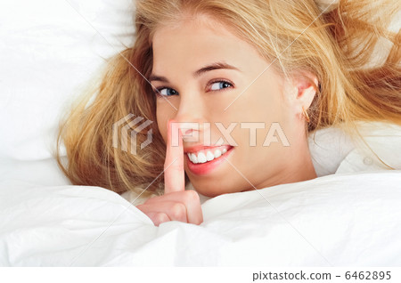 beautiful young blond woman on the bed at home 6462895