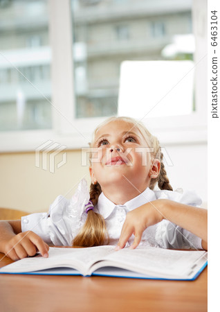 Portrait of a young girl in school at the desk. Portrait of a young girl in school at the desk. 6463104