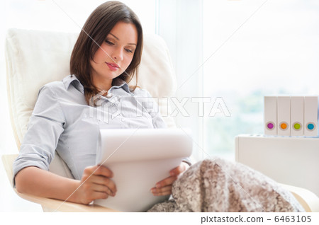 Portrait of a sensual young woman reading a novel while sitting Portrait of a sensual young woman reading a novel while sitting 6463105